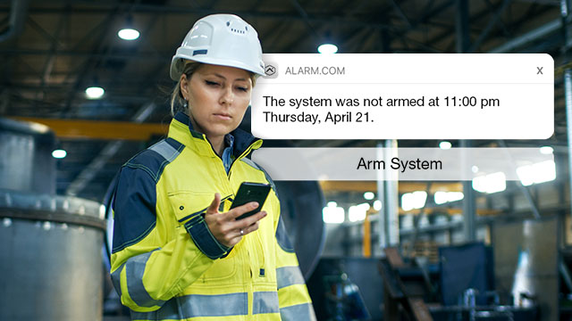 A woman receives a security alert on her smart phone