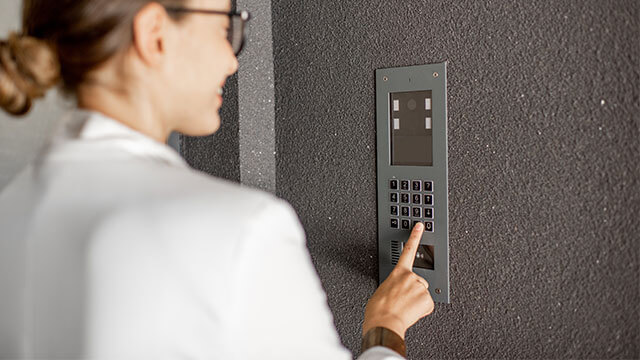 A woman using an intercom system